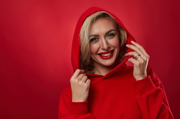 Stylish fashion blonde woman on red background