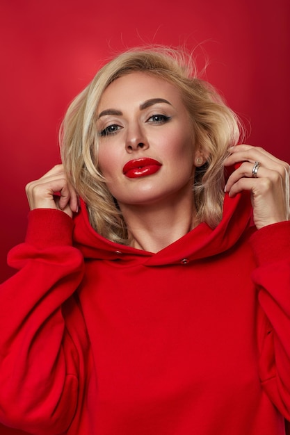 Stylish fashion blonde woman on red background