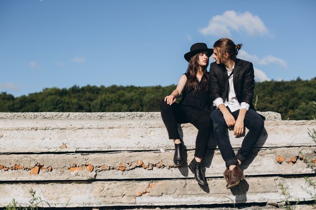 Stylish and fashionable couple spending time outdoors and flirting with each other. 