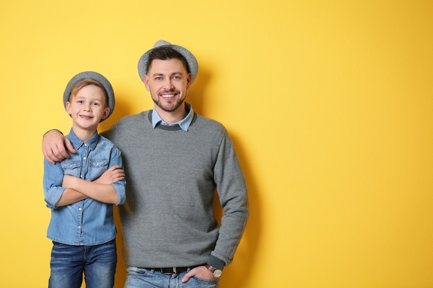 Stylish father and son on yellow