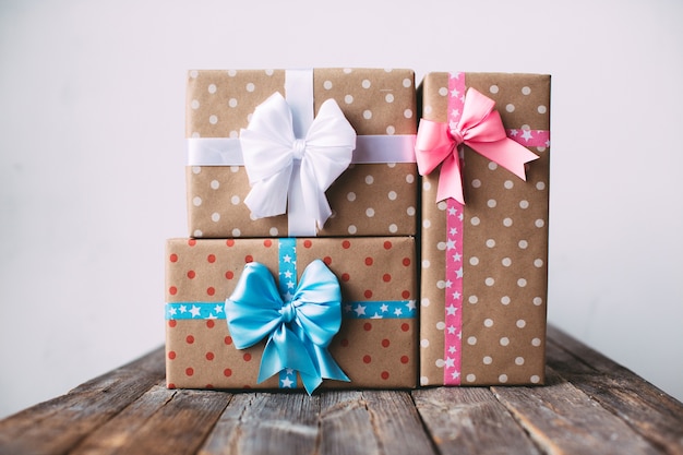 Stylish gift boxes on a wooden table