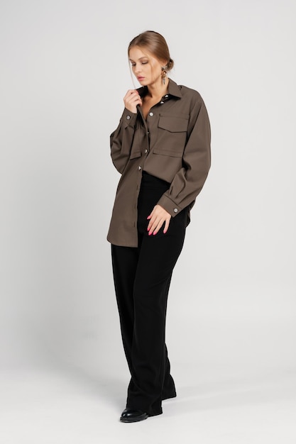 Stylish girl in a blouse and trousers Studio portrait