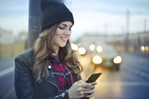 Stylish girl texting in the city