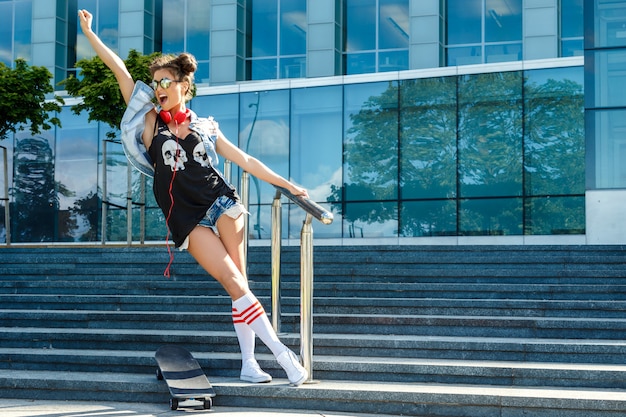 Stylish girl with a skateboard