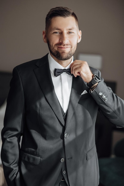 Stylish groom portrait getting ready in the morning for wedding ceremony Morning of the groom