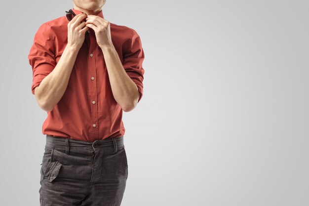  Stylish guy fastens his shirt.