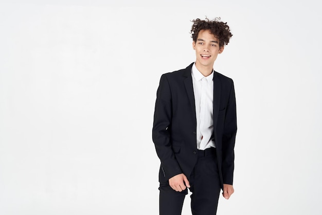 Stylish guy with curly hair and in a jacket shirt pants model High quality photo