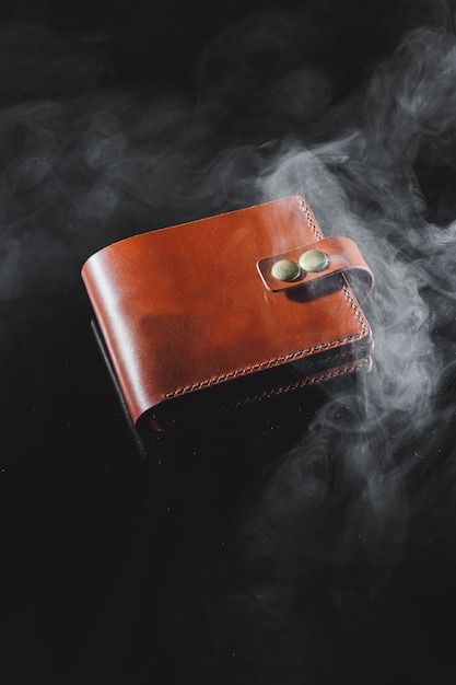 Stylish handmade brown leather wallet on a gray background Product made of genuine leather