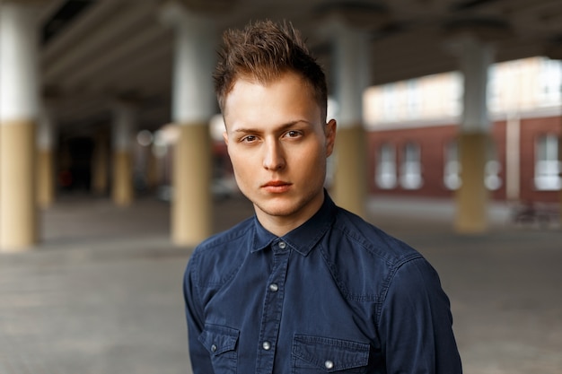 Stylish handsome man in a shirt on the street