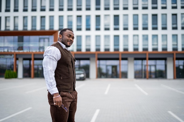 Stylish handsome man walking outdoor Fashionable male model in suit walking on the street