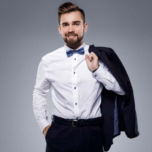 Stylish handsome man wearing a classic suit with bow-tie