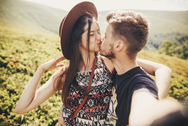 Portrait of young couple kissing each other posing to selfie Stock Photo -  Alamy
