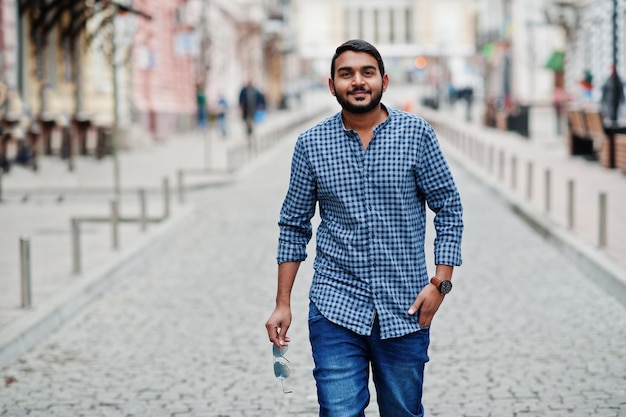 Stylish indian beard model man in casual clothes posed outdoor at street of India