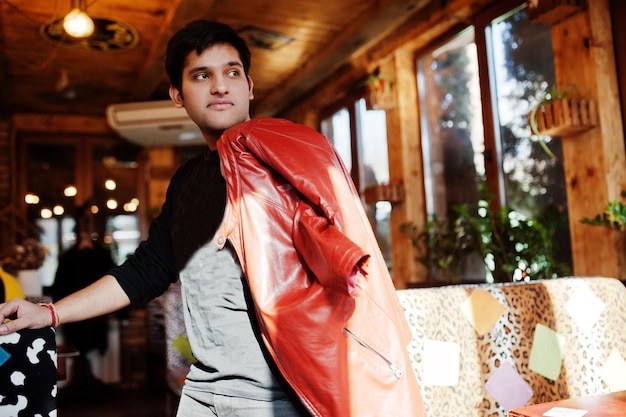 Stylish indian man in casual wear posing indoor cafe