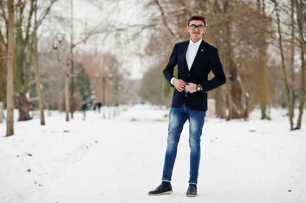 Stylish indian student man in suit and glasses posed at winter day outdoor