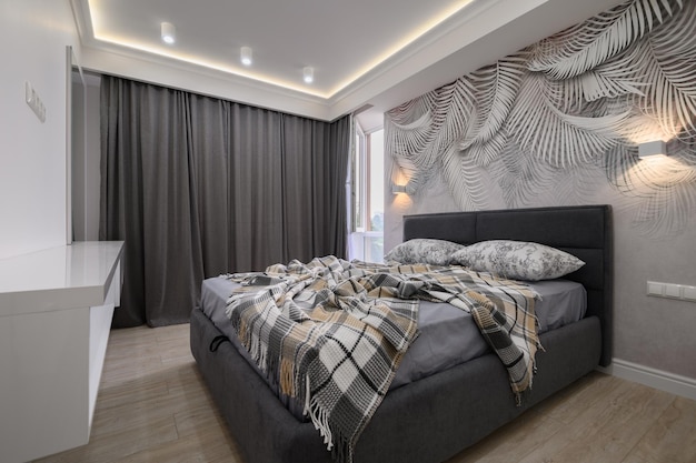 Stylish interior of bedroom with comfortable bed