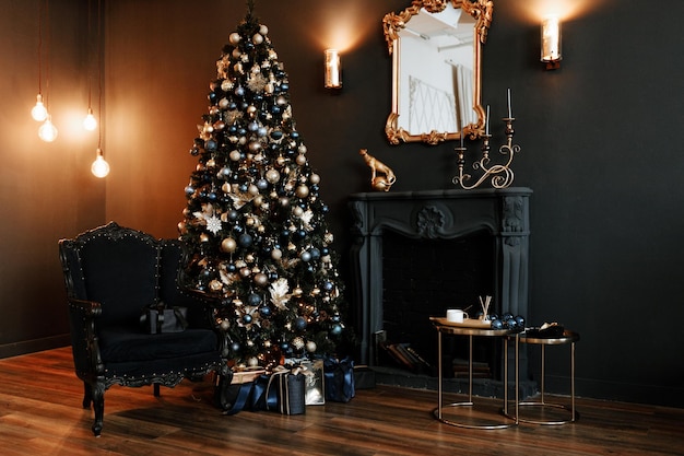 Stylish interior of a dark living room with a decorated Christmas tree