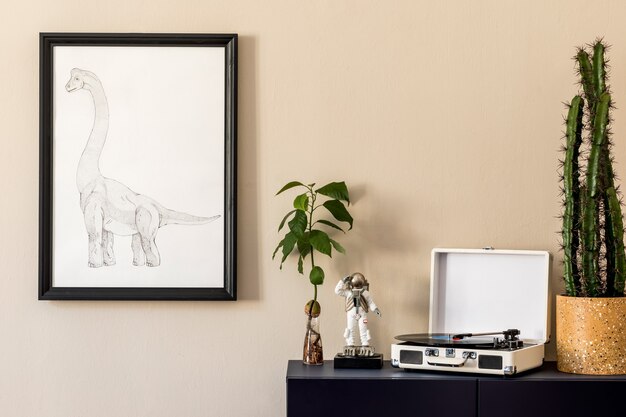 Stylish interior of living room with black mock up poster frame, plants, blue navy commode, decoration  and elegant personal accessories. Beige walls. Modern home staging. Template.