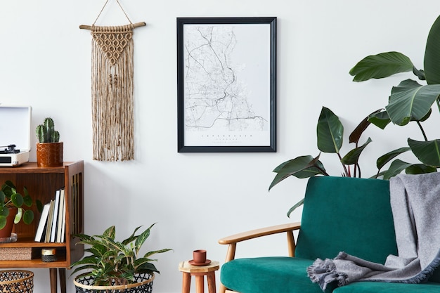 Stylish interior of living room with design wooden shelf,\
velvet sofa, a lot of plants, poster map, vinyl recorder, book,\
macrame and personal accessories in vintage home decor.