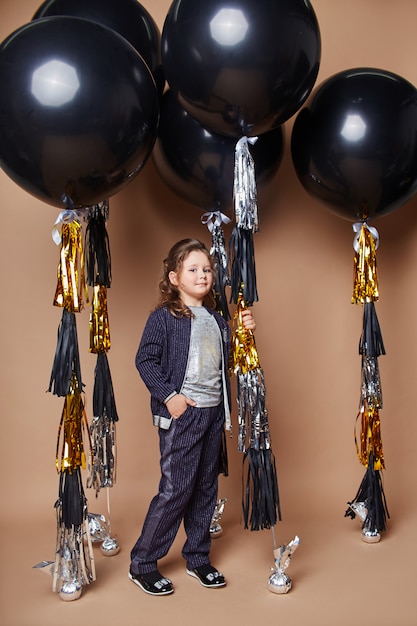 Stylish kids in evening dresses and costumes celebrating the first day of school