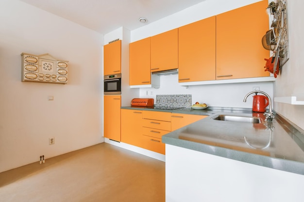 Stylish kitchen design with orange kitchen set