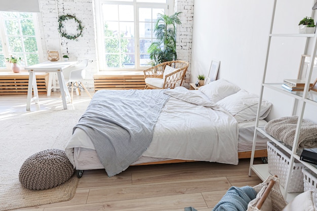 Stylish loft bedroom interior with large windows