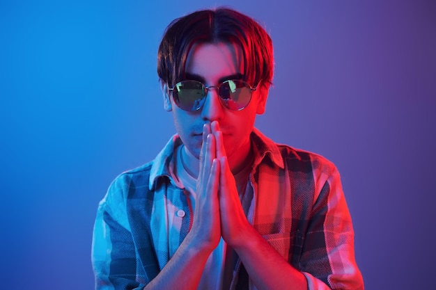 Stylish look man standing in the studio with neon light