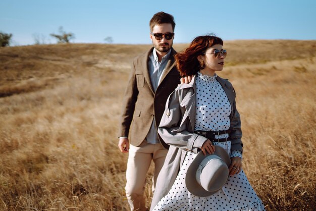 Stylish and loving couple enjoying each other outdoors Stylish couple walking and hugging