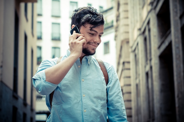 stylish man in the street at the phone