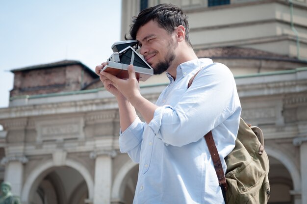 stylish man in the street with old camera 