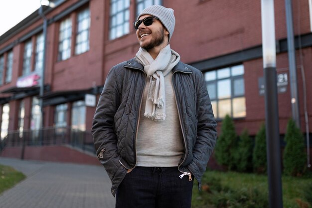 Stylish man in sunglasses and hat outside