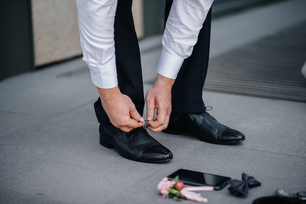 A stylish man wears classic shoes close-up. Fashion.