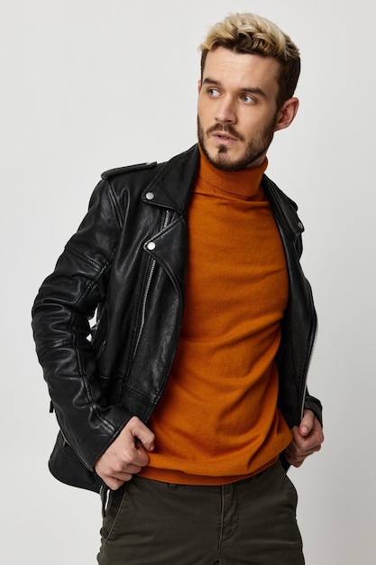 Stylish man with beard blond orange sweater pants leather jacket