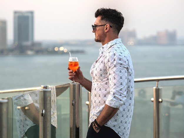 Stylish man with a glass of drink