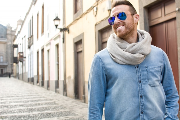 Stylish man with sunglasses and a scarf