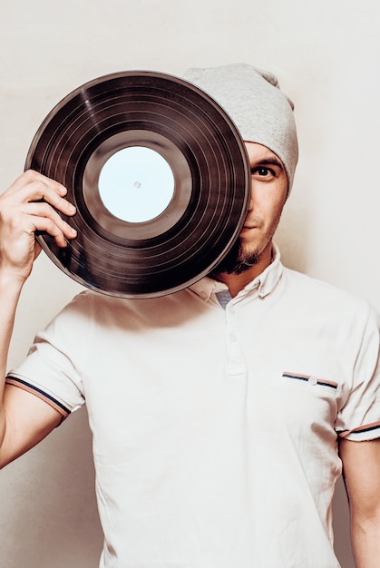 Stylish man with vinyl record