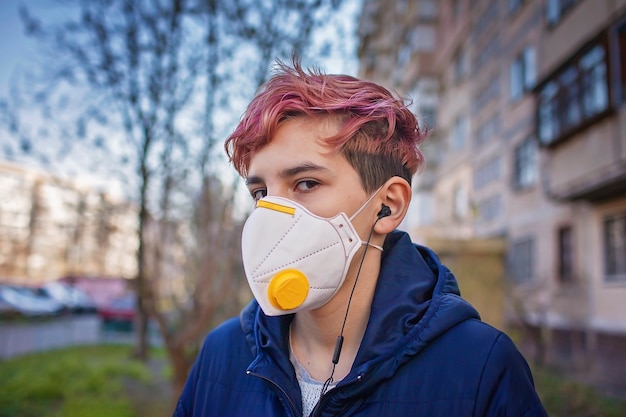 Stylish millennial girl wearing medical respirator listening music with earphone gen z