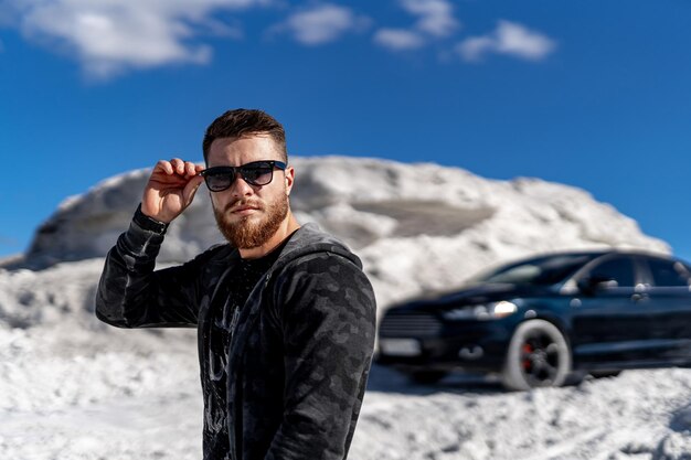 Stylish model posing with car. Young handsome fashionable businessman.