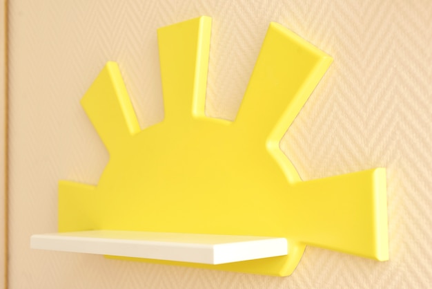 Stylish and modern Interior design. Home for the child room. close-up of a children's wooden shelf in yellow for a children's room.