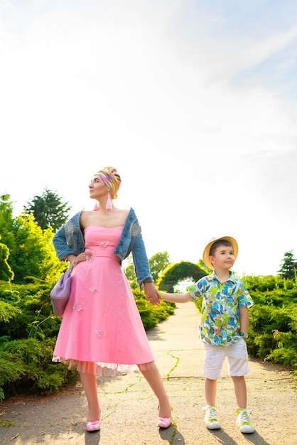 Stylish mum plays with son in park