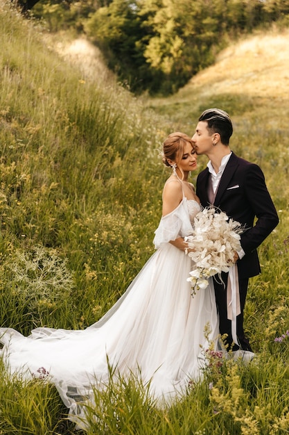 Stylish newlywed couple in love together in nature high quality photo