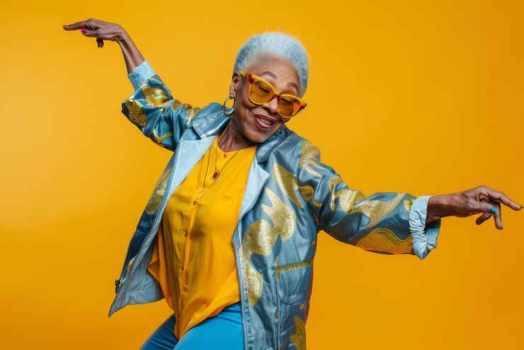 Stylish older black woman in modern clothes dancing energetically