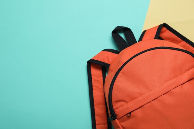 Photo stylish orange backpack on color background top view space for text