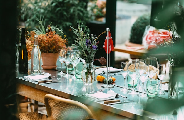 Stylish Outdoor Dinner Party. Decorated  Table with beautiful wild flower bouquets.