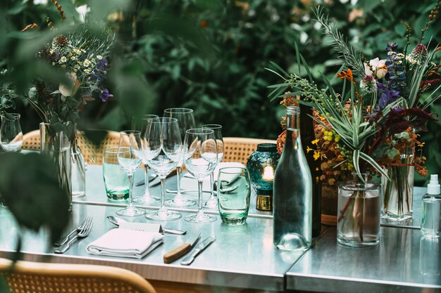 Stylish Outdoor Dinner Party. Decorated  Table with beautiful wild flower bouquets.