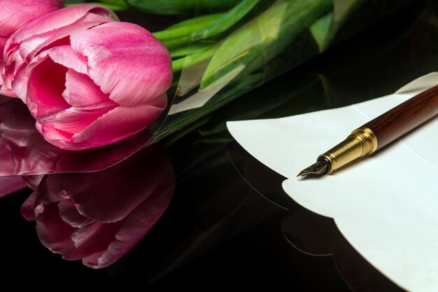 Stylish pen on a postcard for congratulations and flowers