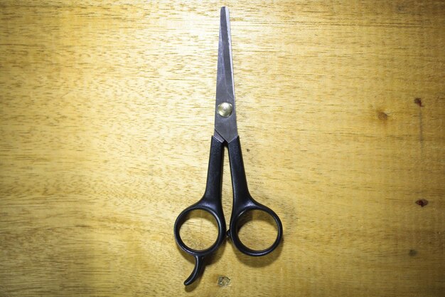 Stylish Professional Barber Scissors Hair Cutting on wooden background