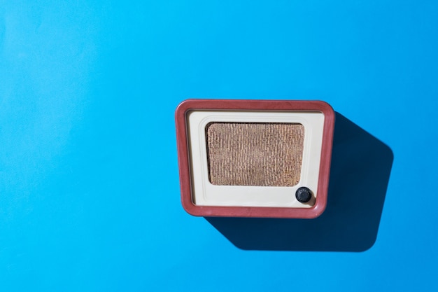 Stylish retro radio on a blue wall. radio broadcast live.\
vintage technique.