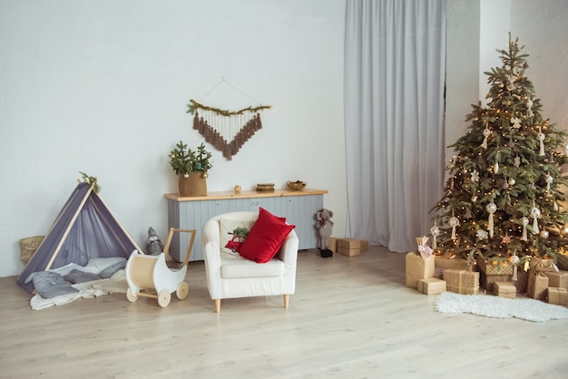 stylish room interior with beautiful christmas tree and gift boxes