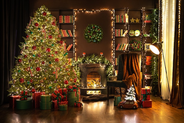 Stylish room interior with fireplace cozy armchair beautiful christmas tree in evening cozy home